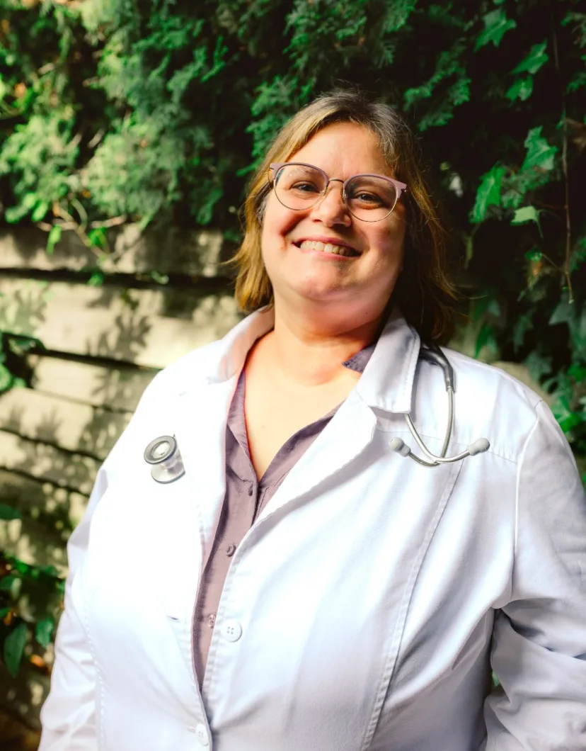 Dr. Melanie in her white coat.